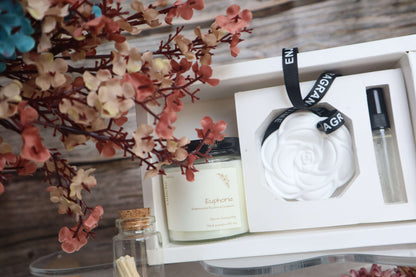 Luxurious Mother's Day gift set featuring hand-poured soy candle, elegant rose car diffuser, and matchsticks.