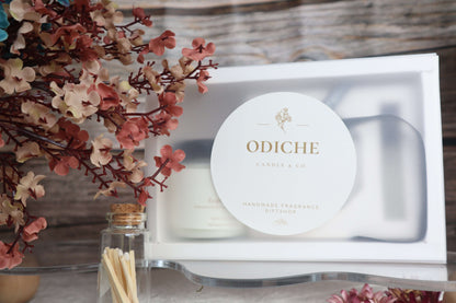 Luxurious Mother's Day gift set featuring hand-poured soy candles, a diffuser, and floral accents.