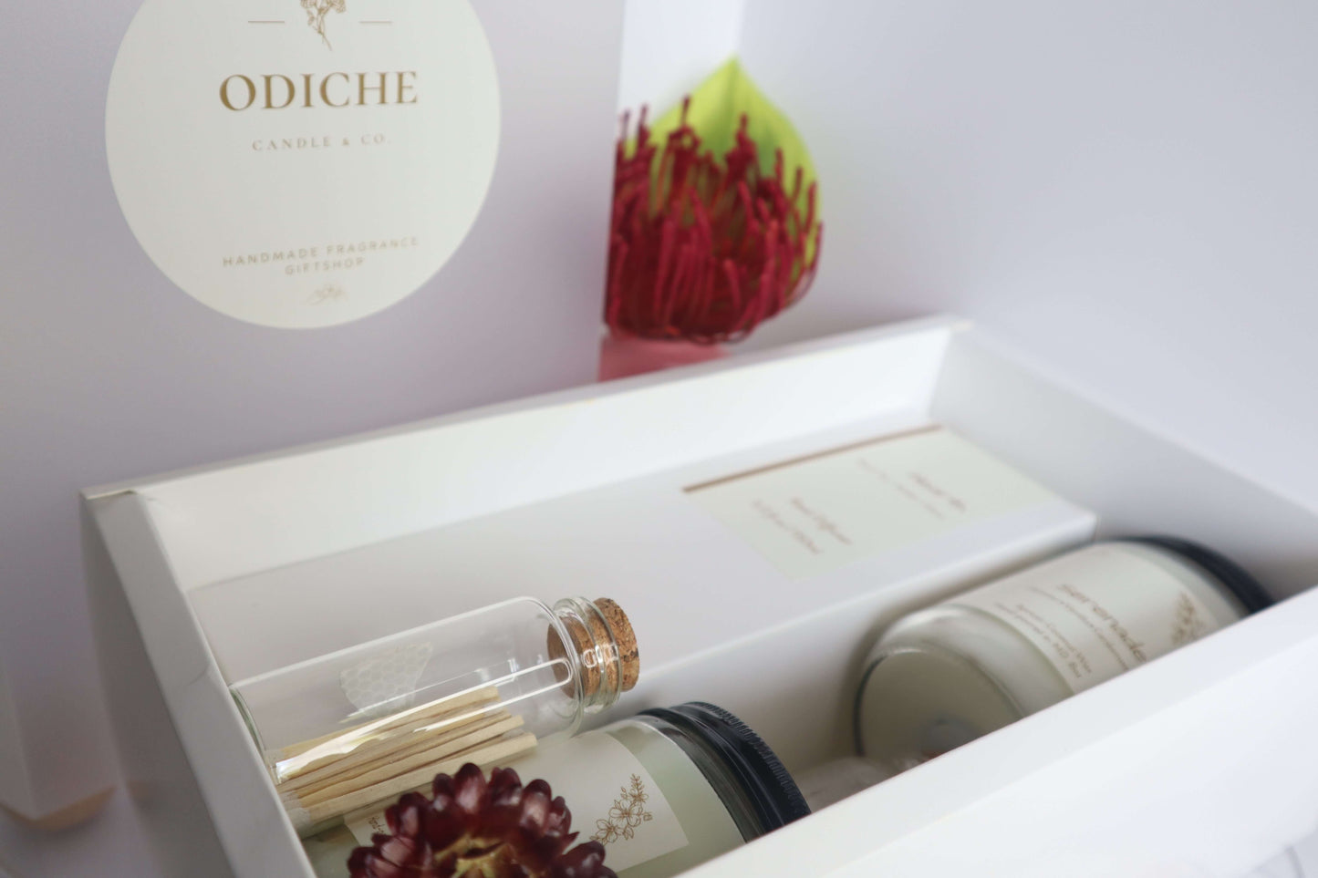 Luxury scented candle gift set featuring hand-poured soy candles and decorative matches in elegant packaging.