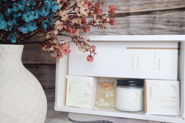 Elegant Mother’s Day gift set featuring hand-poured soy candles and decorative accents with colorful dried flowers.